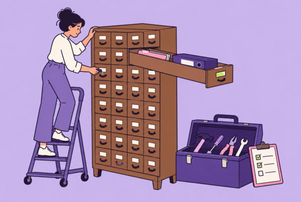 A person on a library step stool pulls one long drawer from a card catalog, revealing a slim folder and a thick binder, beside an open toolbox and a checklist